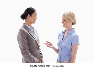 Two Women Talking Happily Against White Background