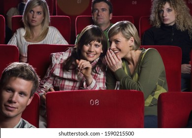 Two women talking in movie theater - Powered by Shutterstock