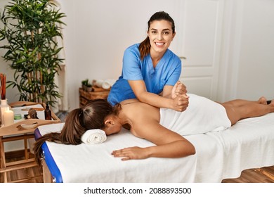 Two women therapist and patient having massage session massaging back at beauty center - Shutterstock ID 2088893500