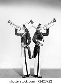 Two women in a toy soldier uniforms with trumpets