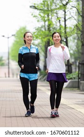 Two Women Walking In The City