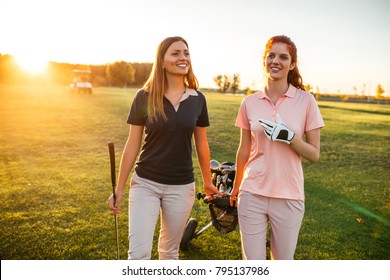 Two Women Walking On The Golf Coarse