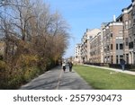 Two women walking on the Monon Greenway Trail next to apartment buildings in Carmel, Indiana