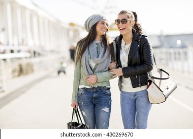 Two Women Walking Together On The Street