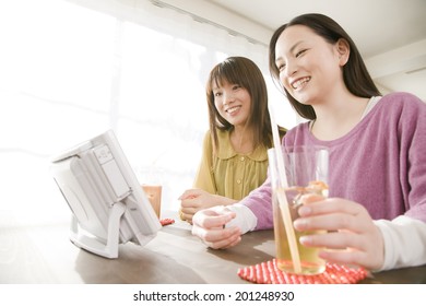 Two Women Watching A DVD