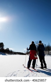 Two women in a winter landscape cross country skiing