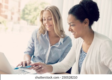 Two Women Working Together In Office