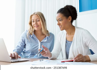 Two Women Working Together In Office