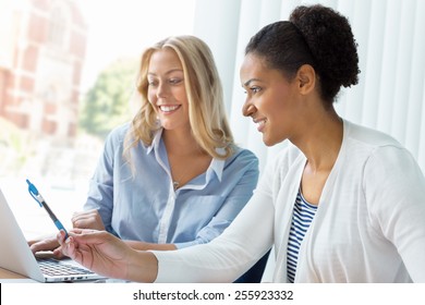 Two Women Working Together In Office