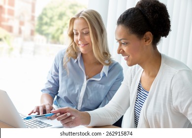 Two Women Working Together In Office