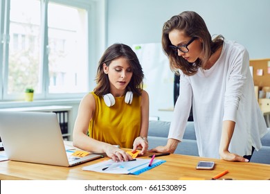 Two Women Working Together At Office