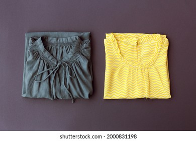 two women's blouses of yellow and gray colors are neatly folded, top view - Shutterstock ID 2000831198