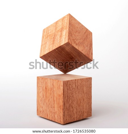 Two Wood Cubes 0n unstable balance