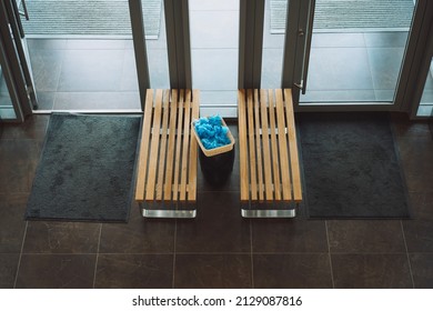 Two Wooden Benches Box With Blue Shoe Covers In The Lobby Of The Sports Medical Center Top View. 