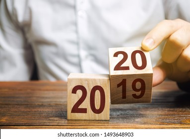 Two wooden blocks with numbers 2019 and 2020. The concept of the beginning of the new year. New objectives. Next decade. Trends and changes in the world. Build plans and goals. Time report