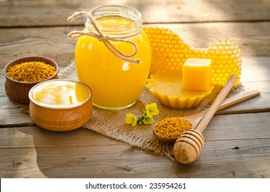 Two Wooden Bowls One With Honey Another With Pollen.The Bank Of Honey Stay Near Honeycombs,wax,wooden Spoon With Honey And Dipper