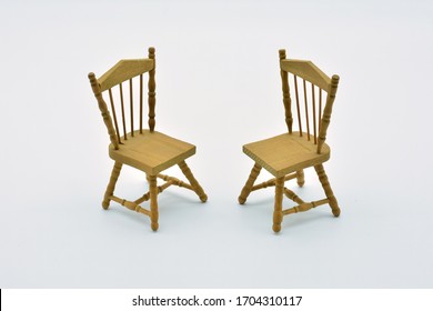 Two Wooden Chairs Facing Each Other, With White Background