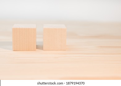Two Wooden Cubes For Your Text, Icons, Sign And Symbols To Create Your Creative Concepts. Mock Up Blank Wooden Cubes. Blocks On Wood Table