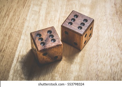 Two Wooden Dice With The Number 6 On A Table.