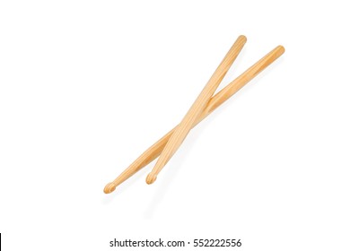 Two wooden drum sticks lying on each other isolated on white background