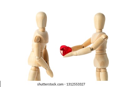 Two wooden figures of a dummy, give a red heart, isolated on a white background - pictures of the theme concepts Love and Valentine's Day. synonymous expression - I give you my heart - Powered by Shutterstock