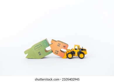 Two Wooden House Model With Front Loader Truck Isolate On White Background, Clearance Sale, Property And Real Estate Business Industry Concept