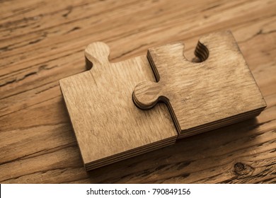 Two Wooden Jigsaw Puzzle Couple Of Pieces Texture Pattern On Wood Texture Background Of Trunk. Empty Copy Space For Inscription Or Objects. Business, Education  Concept