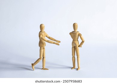 two wooden mannequins as friends or lovers having a discussion and being in denial - Powered by Shutterstock