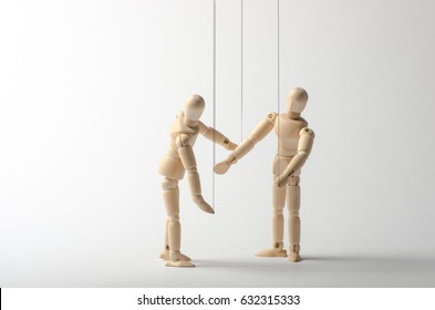 Two wooden mannequins as puppets  on white background.