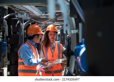 Two worker discuss job in plant room. worker co-worker on Air condition system planton background. engineer female and male checking on Air condition plant. Two worker working on Air condition (HVAC)  - Shutterstock ID 2174105697
