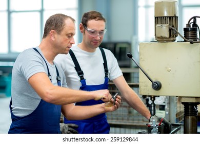 two worker in factory on the machine - Powered by Shutterstock