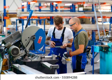 Two Worker In Factory On The Machine