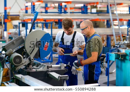 two worker in factory on the machine