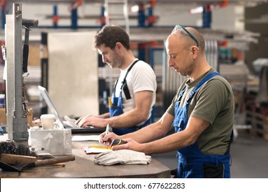 Two Worker In Factory On Work Bench