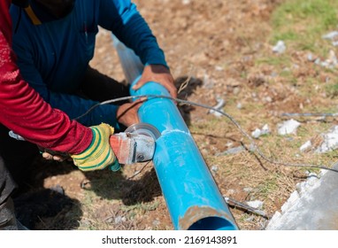 Two Workers Cutting Pvc Trough  Spout For Rooftop Rainwater Drain, Tap Water Systerm.