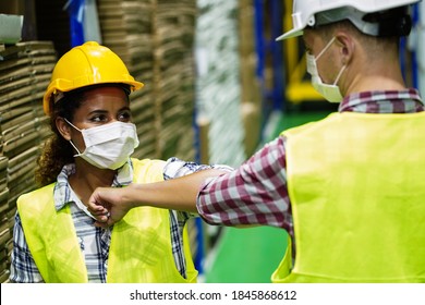 Two Workers In Factory Wear Mask To Protect Covid-19 And Elbow Bump Instead Hand Shake With No Hand Touch