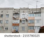 Two workers insulate a typical Soviet house. Energy saving concept.