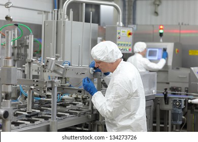 two workers at production line in plant