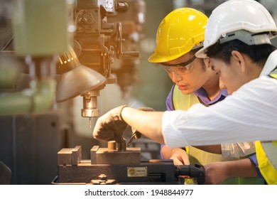 Two Workers In Production Plant As Team Discussing, Industrial Scene In Background, Working Together Manufacturing Activities