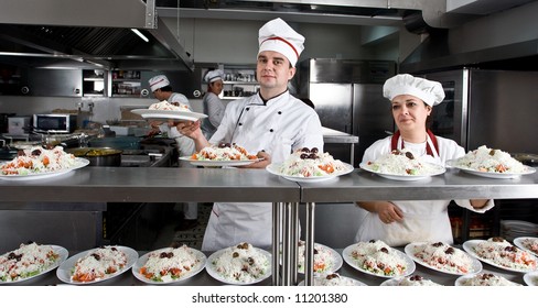 Two Workers In A Restaurant Kitchen