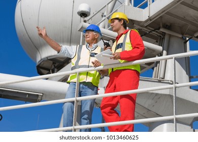 Two workers standing on guardrail - Powered by Shutterstock