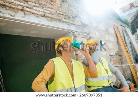 Two workers taking a break at construction site
