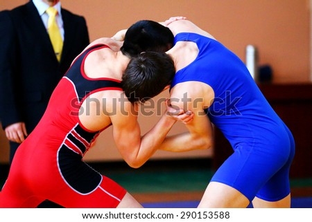 Two wrestlers Greco-Roman wrestling during  competition
