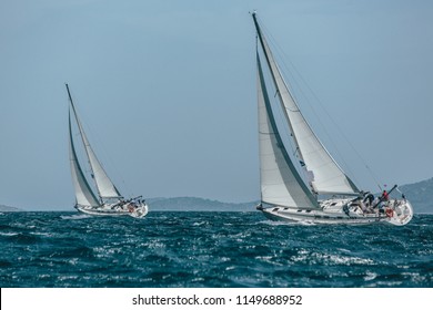 Two Yachts Racing In A Blue Sea 