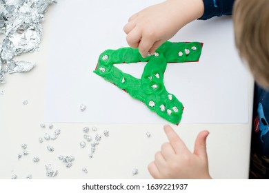 Two Year Boy Decorating Play Dough Letter 