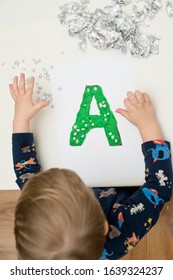 Two Year Boy Decorating Play Dough Letter 