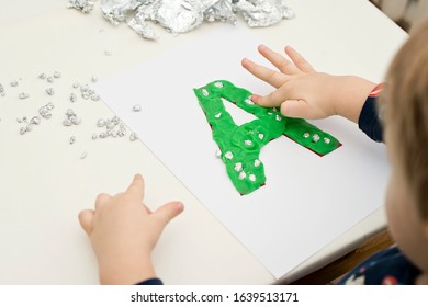 Two Year Boy Decorating Play Dough Letter 