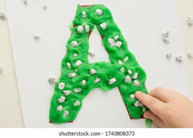 Two Year Boy Decorating Play Dough Letter 