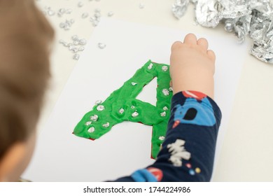 Two Year Boy Decorating Play Dough Letter 