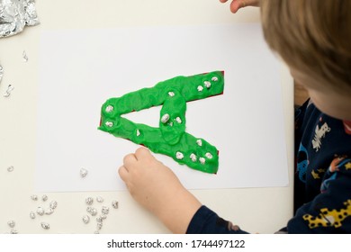 Two Year Boy Decorating Play Dough Letter 